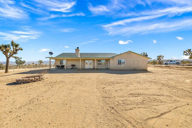 rear view of house featuring a rural view