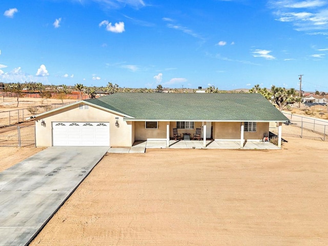 single story home featuring a garage, a patio area, and covered porch