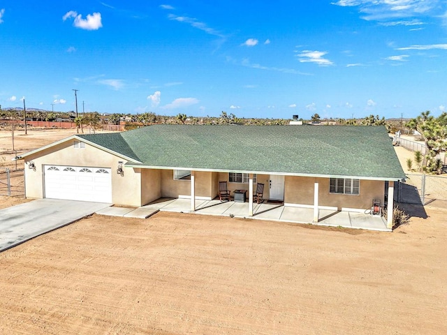 ranch-style home with a patio area and a garage