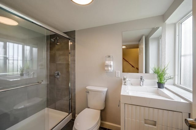 bathroom featuring vanity, toilet, and walk in shower