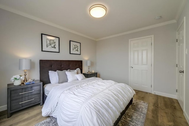 bedroom with hardwood / wood-style flooring and ornamental molding