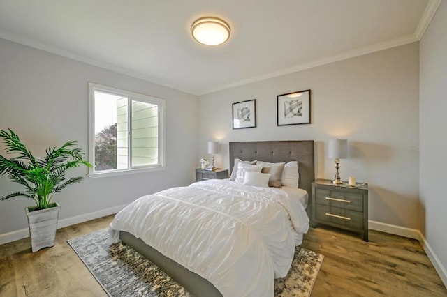 bedroom featuring hardwood / wood-style flooring and ornamental molding