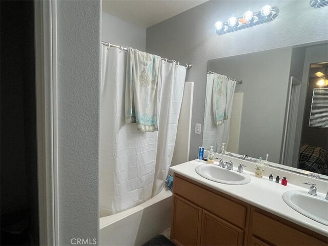 bathroom with vanity and shower / bath combo with shower curtain