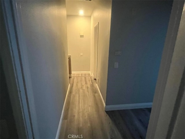 corridor with wood-type flooring