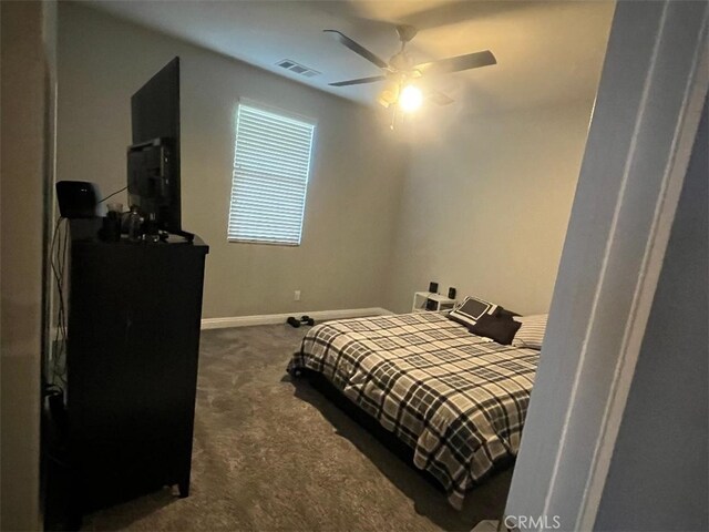 bedroom featuring ceiling fan and dark colored carpet