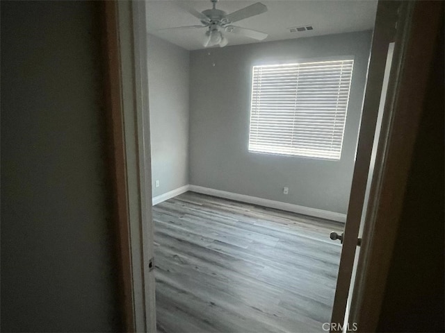 empty room featuring ceiling fan and light hardwood / wood-style floors