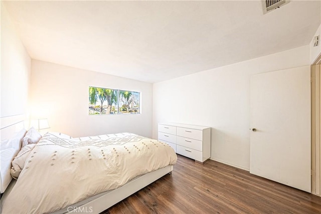 bedroom with dark hardwood / wood-style flooring