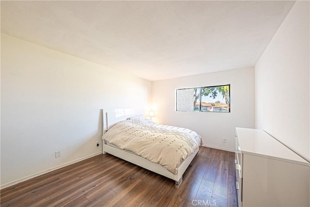 bedroom with dark wood-type flooring