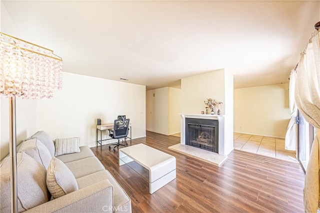 living room featuring wood-type flooring and a notable chandelier