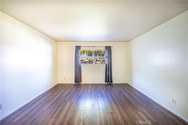 spare room with dark hardwood / wood-style floors