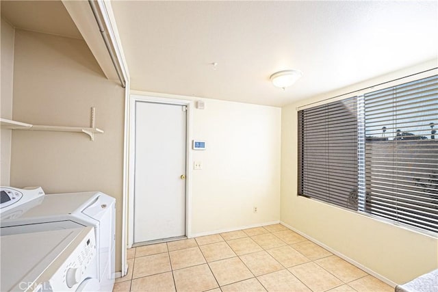 washroom featuring light tile patterned floors and washing machine and clothes dryer