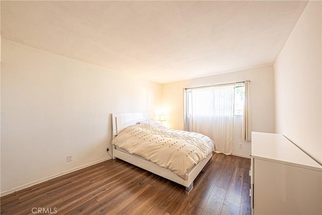 bedroom featuring dark hardwood / wood-style flooring