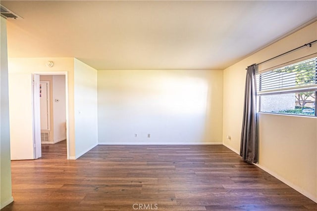 unfurnished room with dark hardwood / wood-style floors