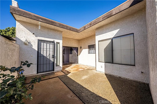 entrance to property with a patio