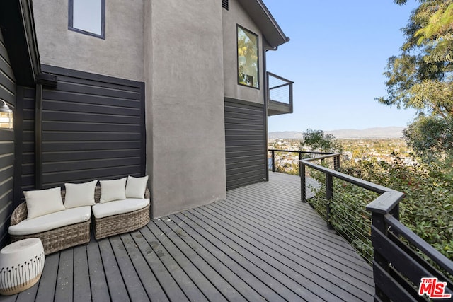 deck featuring a mountain view and outdoor lounge area