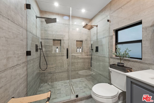 bathroom with toilet, walk in shower, and vanity