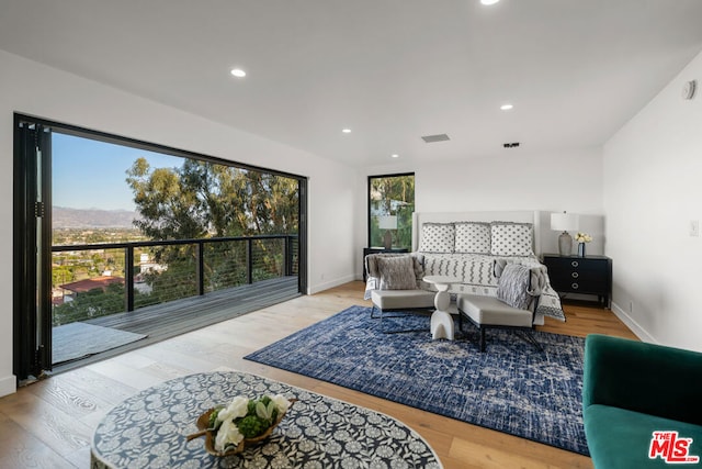 bedroom featuring access to outside and light hardwood / wood-style floors