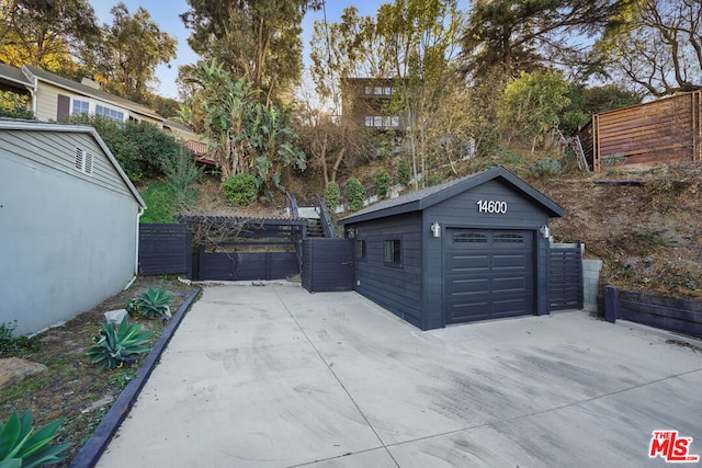 view of patio / terrace featuring a garage and an outdoor structure