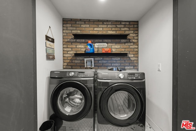 clothes washing area with washer and dryer