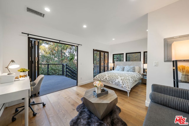 bedroom featuring light wood-type flooring and multiple windows