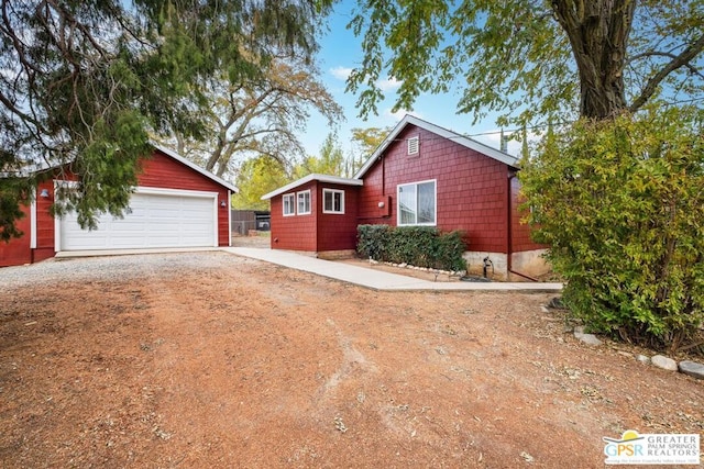 view of front of property featuring a garage and an outbuilding