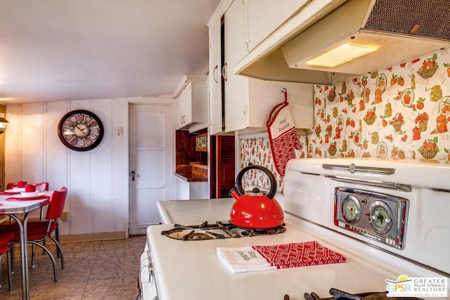 kitchen featuring white cabinetry and range