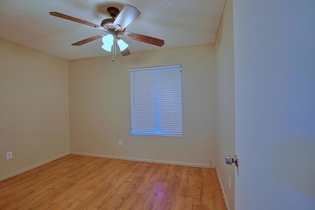 spare room featuring ceiling fan, a textured ceiling, and light hardwood / wood-style floors