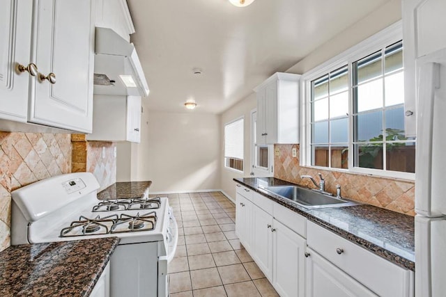 kitchen featuring light tile patterned flooring, white cabinetry, sink, exhaust hood, and white appliances