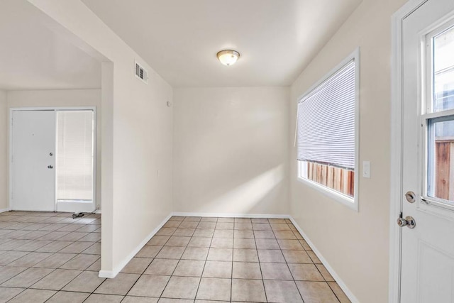 unfurnished room featuring light tile patterned flooring