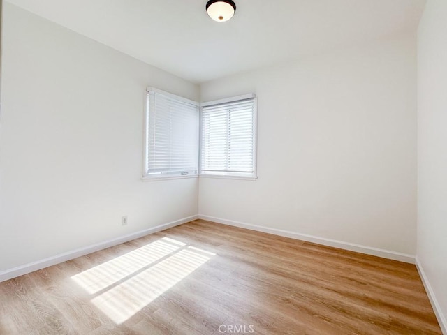 spare room featuring light wood-type flooring