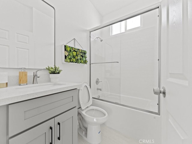 full bathroom featuring toilet, enclosed tub / shower combo, and vanity