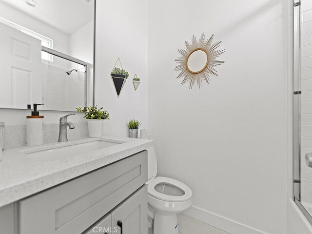 bathroom featuring tile patterned floors, toilet, and vanity