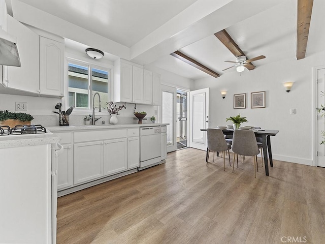 kitchen featuring white cabinetry, white dishwasher, and beamed ceiling