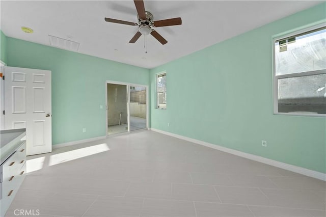 unfurnished bedroom with ceiling fan, light tile patterned floors, a closet, and multiple windows