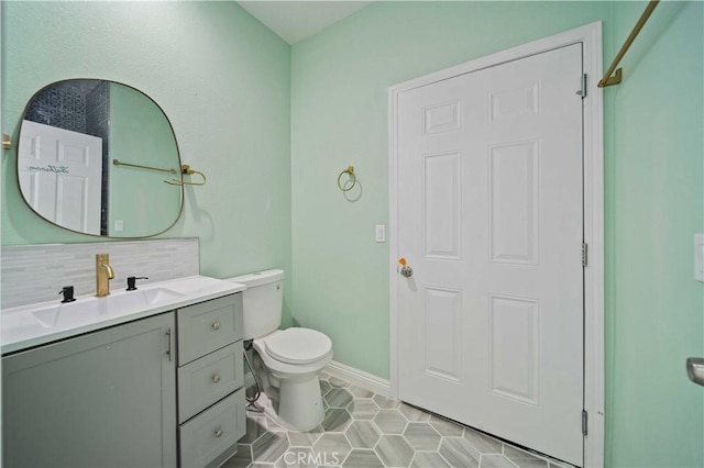 bathroom featuring decorative backsplash, tile patterned floors, vanity, and toilet