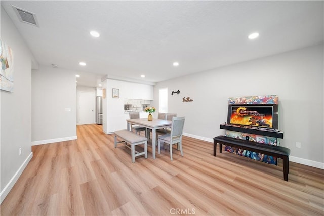 dining area with light hardwood / wood-style flooring