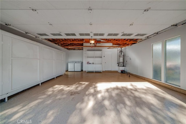 garage with washer and clothes dryer and water heater