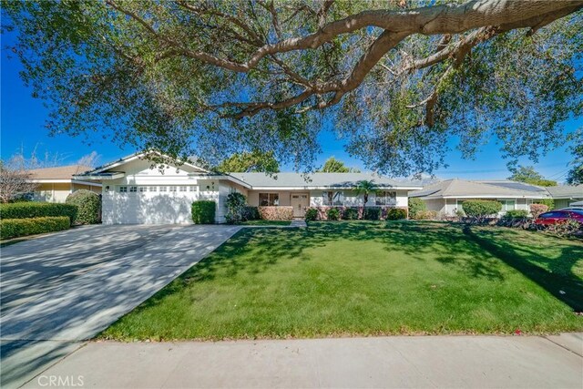 ranch-style house featuring a garage and a front yard