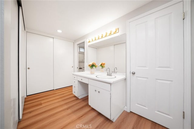 bathroom with hardwood / wood-style floors and vanity