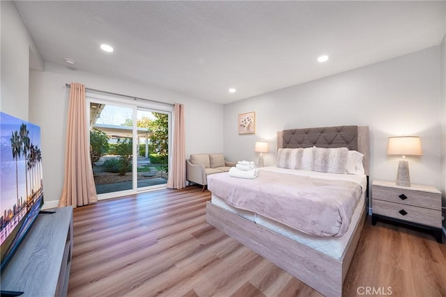 bedroom with access to exterior and wood-type flooring