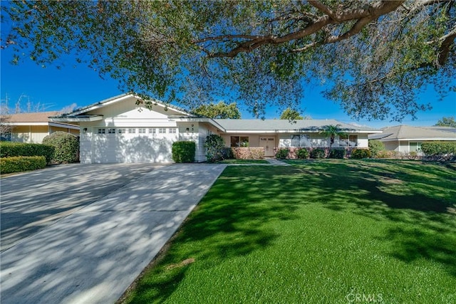 ranch-style home with a garage and a front lawn