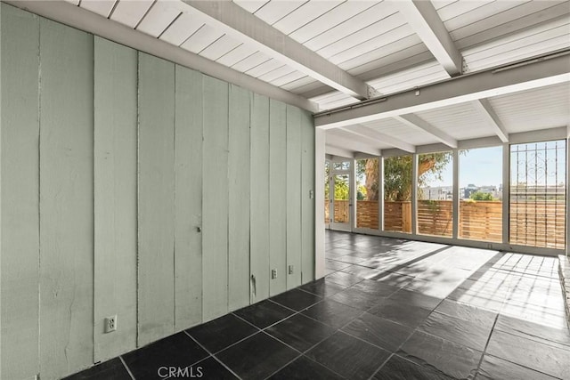 unfurnished sunroom with beam ceiling