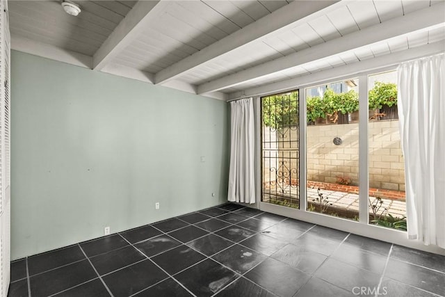 unfurnished room featuring beam ceiling