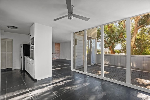 interior space with ceiling fan