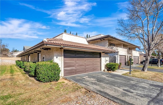 view of front of property with a front lawn and a garage