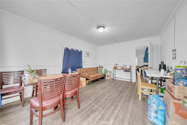 dining area featuring hardwood / wood-style flooring and ornamental molding