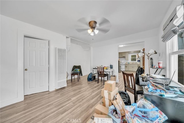 misc room with ceiling fan and light hardwood / wood-style floors