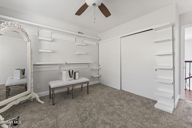 interior space with ceiling fan and carpet flooring