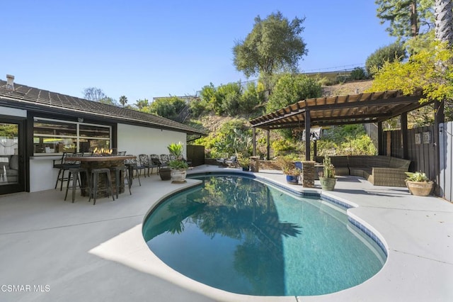 view of swimming pool with a patio area, a bar, an outdoor hangout area, and a pergola