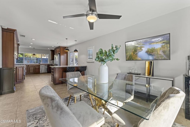 dining room with ceiling fan and light tile patterned flooring